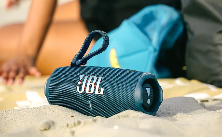 JBL Charge 6 azul na praia — resistente a água e poeira